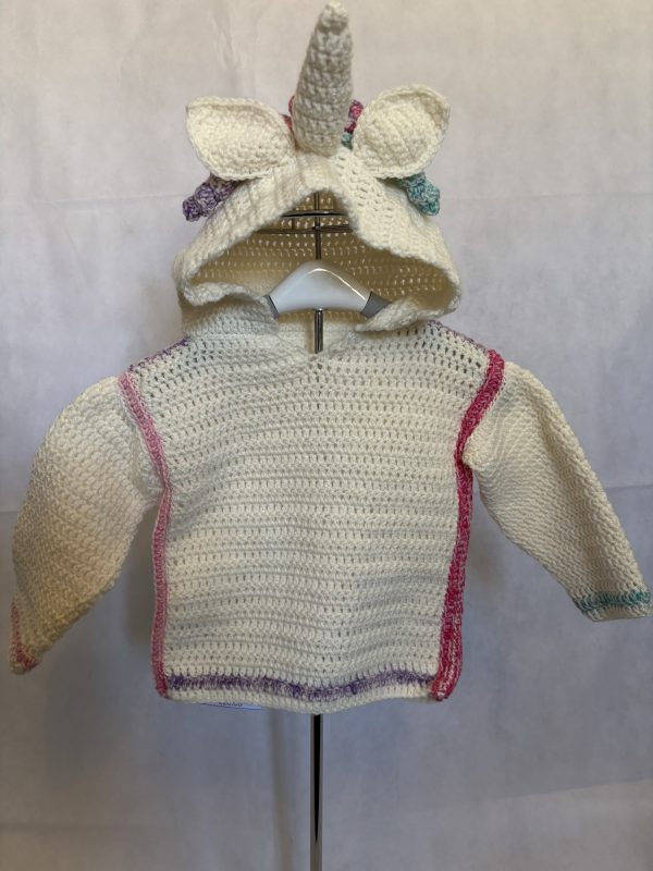 Handmade crocheted unicorn hoodie for 6 - 12 months old. Made to an original design by Lisa.